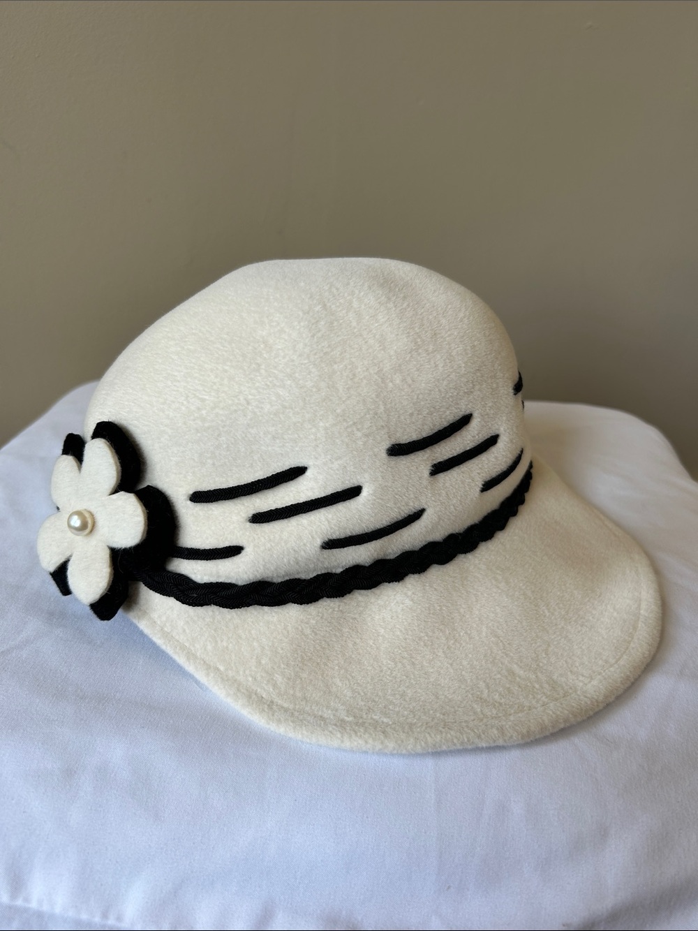 Cream felt hat with black detailing and flower